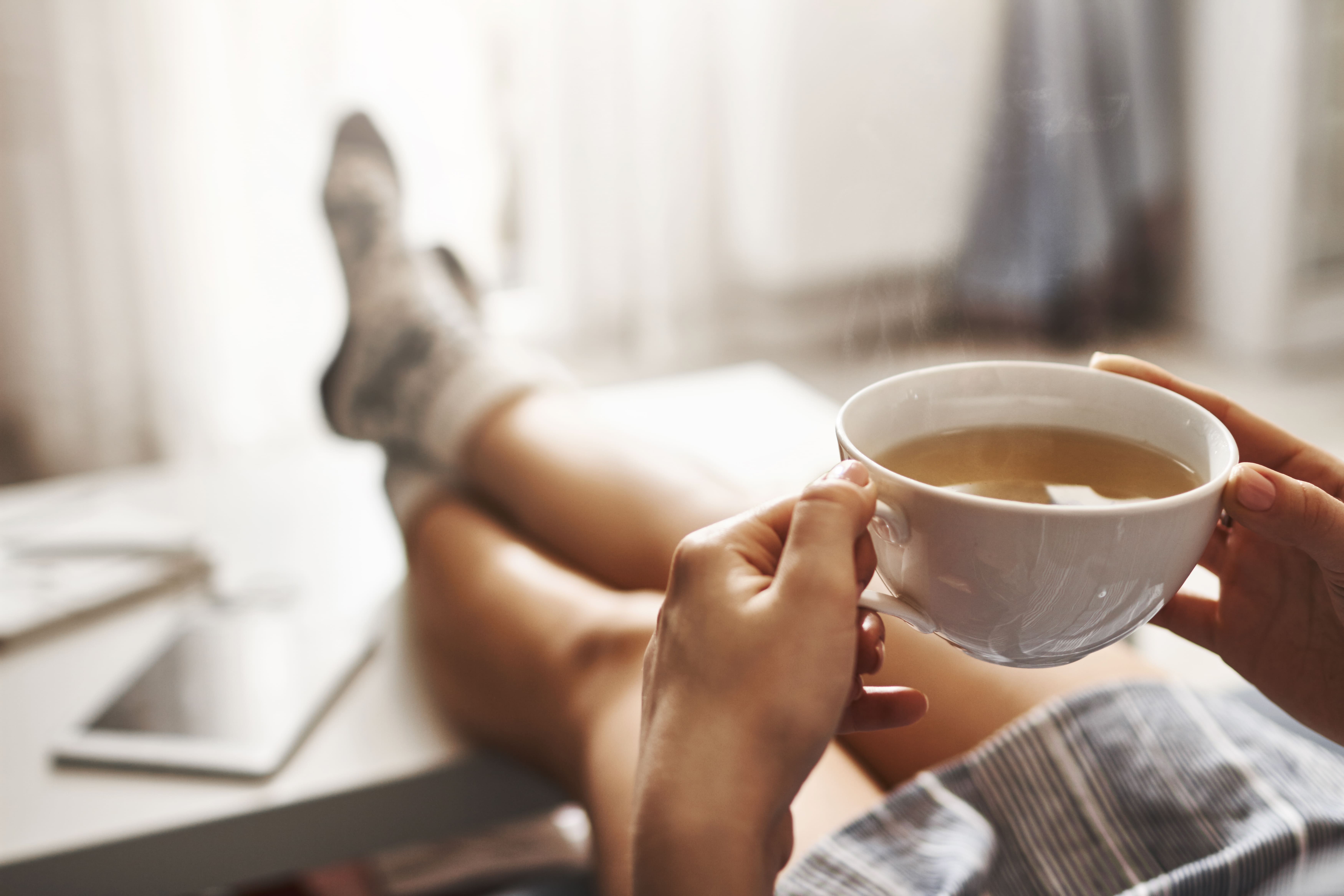 cup-tea-chill-woman-lying-couch-holding-legs-coffee-table-drinking-hot-coffee-enjoying-morning-being-dreamy-relaxed-mood-girl-oversized-shirt-takes-break-home (1).jpg